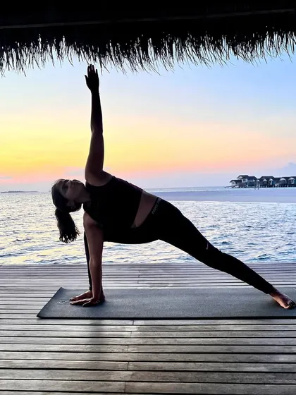 Extended Side Angle Pose, or Parsvakonasana, with the ocean as my backdrop. This pose creates a long line of energy from the back foot to the fingertips, stretching the entire side of the body.
