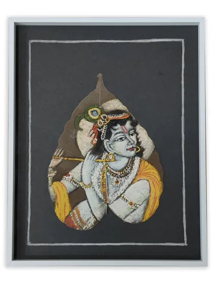 We specialize in framing even the most unusual items. This is a beautiful painting of Krishna on a real leaf, floated on a dark background and housed in a simple white frame to preserve its natural form.
