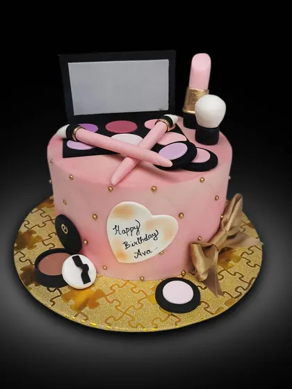 Another makeup-themed cake, this one was a delicious chocolate rum cake. The design features a pink quilted pattern and is topped with an edible eyeshadow palette, lipstick, and brushes.