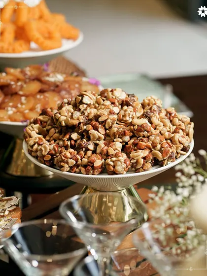 A beautiful display of Indian sweets and savouries, including a delicious nut chikki. Our presentation turns traditional favourites into an art form, perfect for festive gatherings at home.
