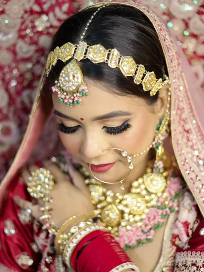 A detailed shot of the eye makeup and jewelry. We emphasize precision in our training, from perfectly blended eyeshadow to the delicate application of the bindi.
