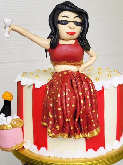 A "Bridechilla" cake for a bachelorette party. The design features a custom fondant topper of the bride-to-be in a lehenga, ready to party.