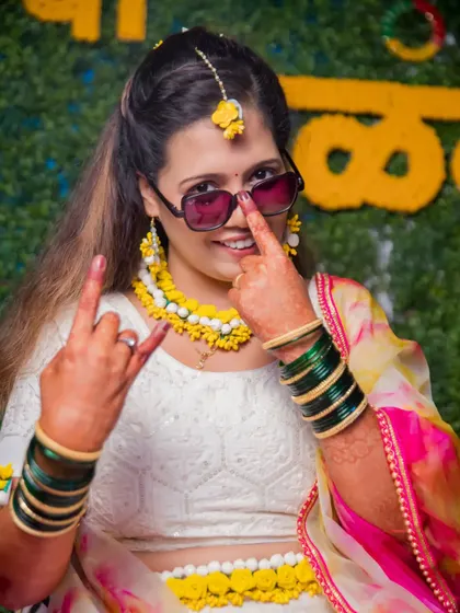 A fun and quirky portrait of the bride during her Haldi, showing off her playful personality.