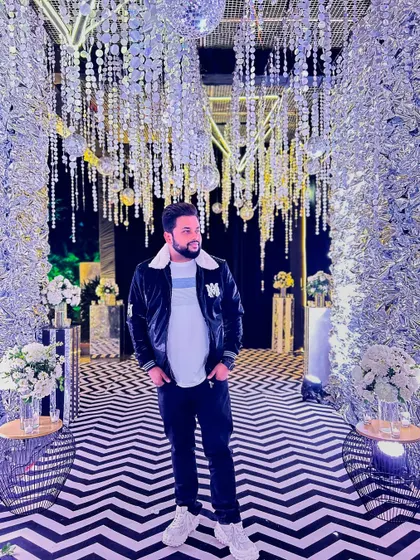 Making my days masterpieces. A stylish photo of me standing in a stunning, brilliantly lit, and decorated event space.