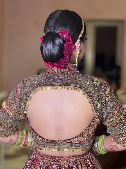 The clean lines of this sleek bridal bun create a very royal and polished look, perfect for a grand wedding ceremony.