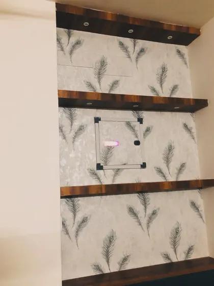 A more subtle feather pattern wallpaper used to decorate a built-in shelving unit.
