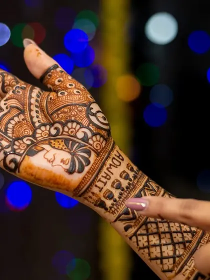Another angle of the bride's beautiful henna art, with her groom's name, Adwait, elegantly written into the design.
