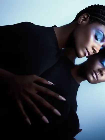 A beauty-focused version of the "two-faced" concept. The reflection is used to create a perfectly symmetrical, almost alien-like portrait.