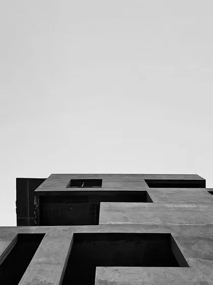 Black and white site photos documenting the construction of the SBR Earth & Sky project in Bangalore, capturing the raw concrete structure and powerful forms.