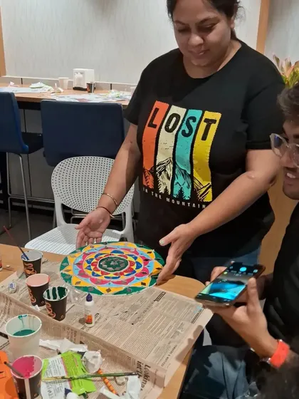 I am always on hand to offer guidance and support. Here, I'm helping a participant with the placement of their design elements to ensure they get a result they love. No one is ever left feeling stuck or unsure.