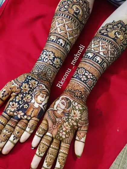 A full bridal design featuring couple portraits surrounded by a beautiful mix of floral and geometric patterns. The arms include bands of elephants and check-work for a complete look.