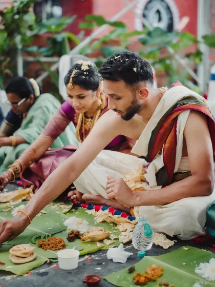 The traditional South Indian feast, 'Sadhya', served on banana leaves. We coordinate with caterers to ensure every aspect of the guest experience, including the food, is authentic and well-presented.