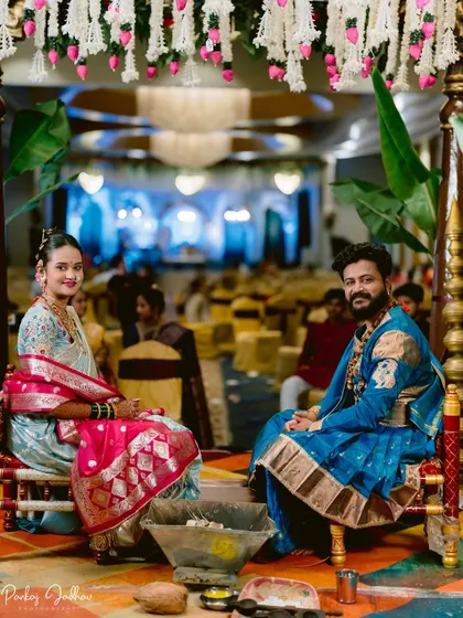 A wide shot of the wedding ceremony, capturing the couple at the mandap.