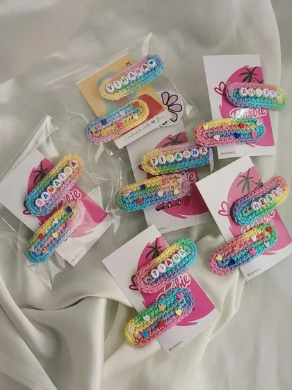A beautiful display of multiple name clip orders, showing the consistent quality and vibrant colors of our handmade accessories.