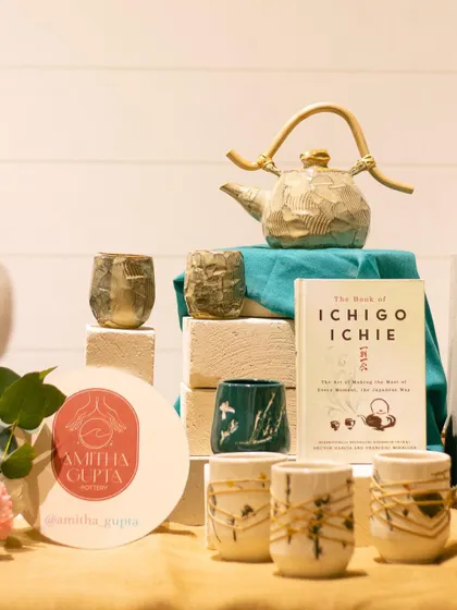 A display of teapots and cups from Amitha Gupta's "Ichigo Ichie" collection at the GLAZED exhibit.