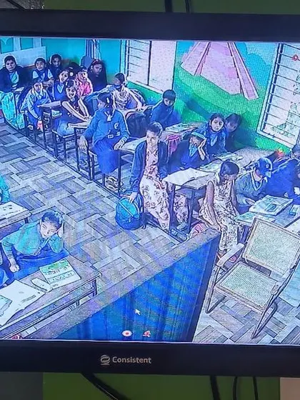 A classroom with a teacher interacting with students.