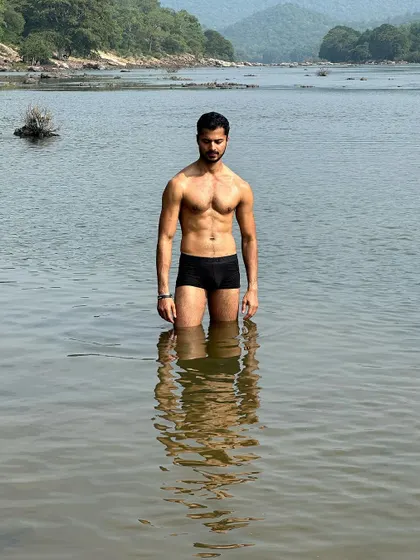 A powerful shot standing in a river, with my reflection in the water. This combines my love for nature with my dedication to fitness.