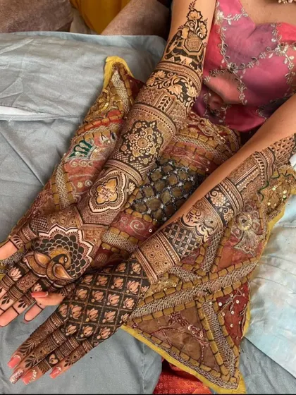 A rich and complex design with multiple layers of different patterns, including paisley, floral, and geometric elements.