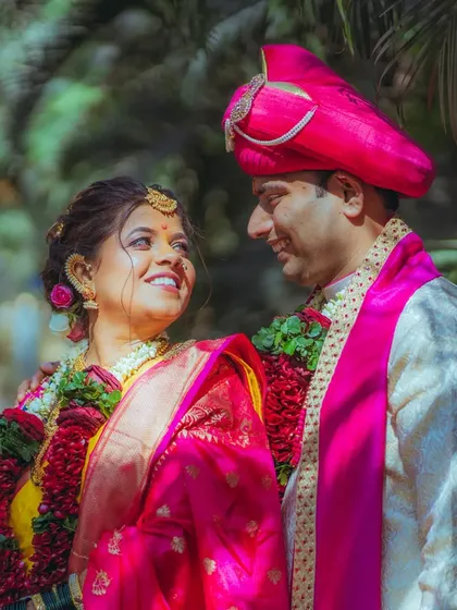 The beautiful, vibrant colors of a traditional Maharashtrian wedding. Here, Pratiksha and Nitesh share a sweet glance, surrounded by lush greenery. I love capturing the unique cultural details and bright emotions of every ceremony.