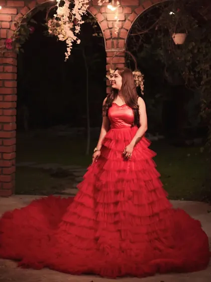 This red tiered ruffle gown is a showstopper, perfect for a glamorous night-time pre-wedding photoshoot.