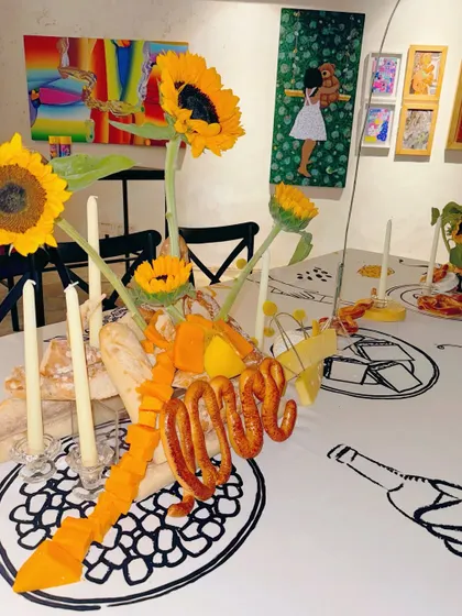 Another creative edible sculpture, with cheese slices and bread forming a ribbon-like design.