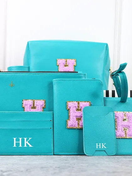 Travel with a touch of elegance. My Monogram Travel Combo in a vibrant teal with a pink initial is perfect for those who love to explore in style.