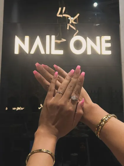 Another shot of a client proudly displaying her new nails at our salon. Your satisfaction is our top priority.