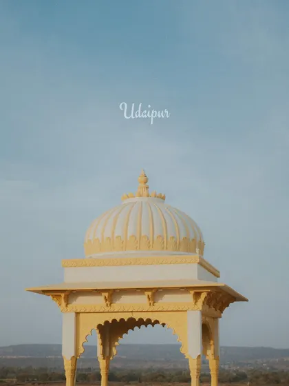 An atmospheric shot of a palace dome against the sky, setting the scene for a royal destination wedding.