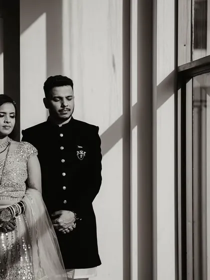 The black and white version of the dramatic window portrait. Removing the color emphasizes the play of light and shadow, giving the image of Shweta and Onkar a classic, cinematic quality.