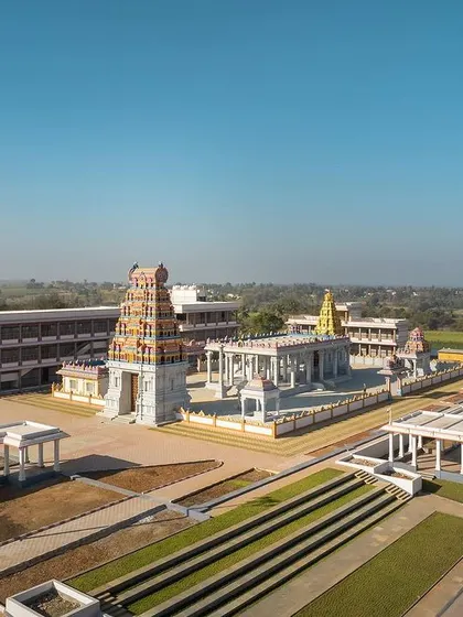 The stepped green lawns and wide pathways create a grand approach to the temple, allowing for large gatherings during festivals while maintaining a sense of order.