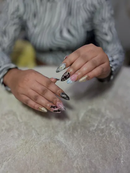 A mixed-media design featuring snakeskin and other textured patterns. Learning to create animal prints is a must-have skill for any versatile nail tech.