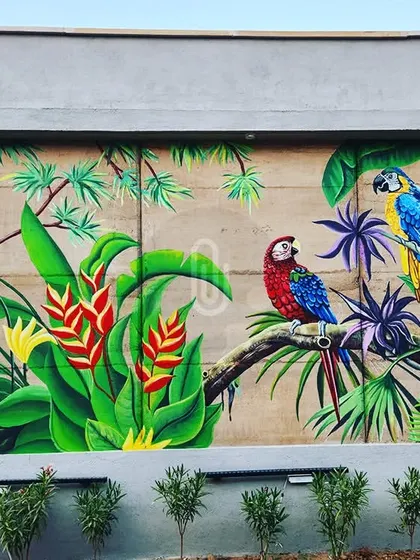 Another mural from the Imperial Golf Resort project, this one featuring two colorful macaws perched on a branch amidst tropical foliage.