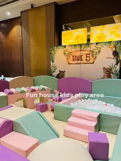The pastel play area set against a jungle-themed backdrop, showing how our setups can anchor the kids' section of a large themed event.