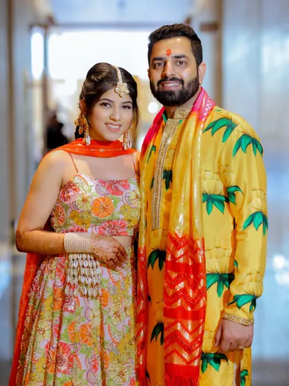A classic portrait of the couple in their vibrant Haldi outfits.