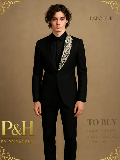 A portrait shot of the black party suit, highlighting the striking contrast between the sharp tailoring and the sparkling, handcrafted lapel.