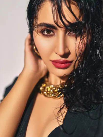 A bold and beautiful look featuring a wet-hair effect and a striking red lip. This close-up shows how a pop of color can transform a look.
