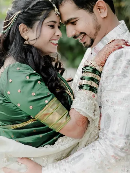 A romantic couple shot from an engagement session. The bride's soft makeup and hairstyle perfectly complement the happy, natural vibe of the photo.