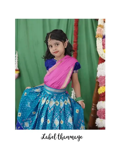 A classic langa blouse in blue and pink. The half-saree style dupatta is perfect for little girls.