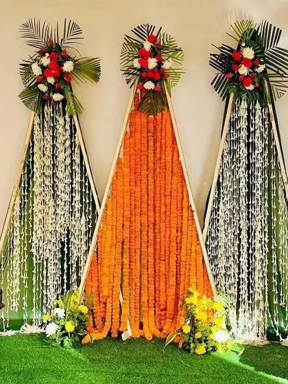 Another angle of the A-frame Haldi backdrop. This design is perfect for clients looking for something different from the usual circular or rectangular stages for their pre-wedding functions.