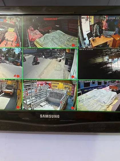 A live view of a 9-camera system on a Samsung monitor. You can see different areas of a shop and the outside street, all on one screen.