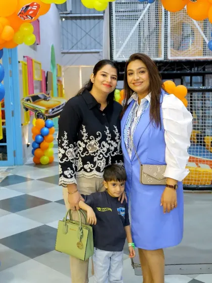 Moms and kids enjoying a birthday party together. It's a celebration for the whole family.