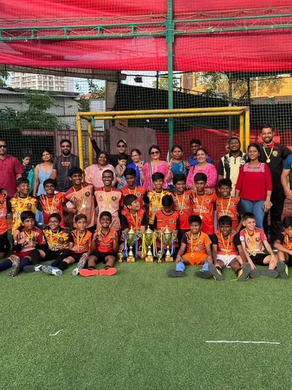 A celebration photo with players, coaches, and parents after a successful Andheri Premier League tournament.