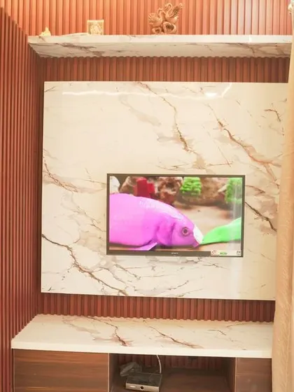 A close-up of the TV unit, showing the texture of the fluted panels and the smooth marble finish. This combination of materials adds depth and visual interest.