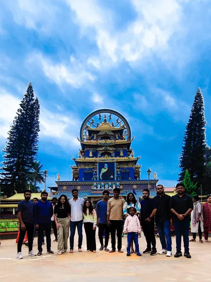 This team stands together against a backdrop of stunning architecture and a brilliant blue sky at the Namdroling Monastery in Coorg. It's a perfect example of the culturally rich experiences I integrate into our offsites.