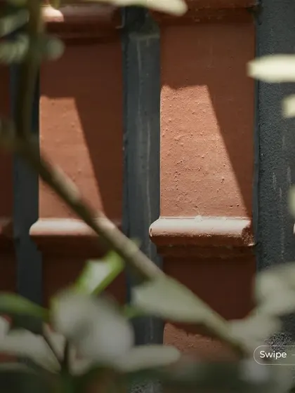 A close-up of the textured terracotta columns, a recurring design element that provides both structural support and aesthetic beauty.