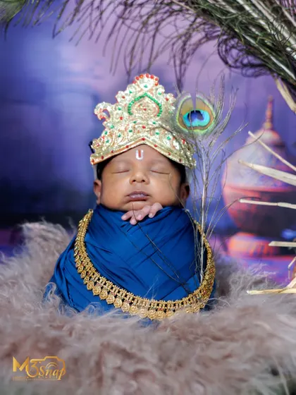 A beautiful Little Krishna portrait. The rich blue wrap, golden jewelry, and peacock feather create a divine and vibrant image.