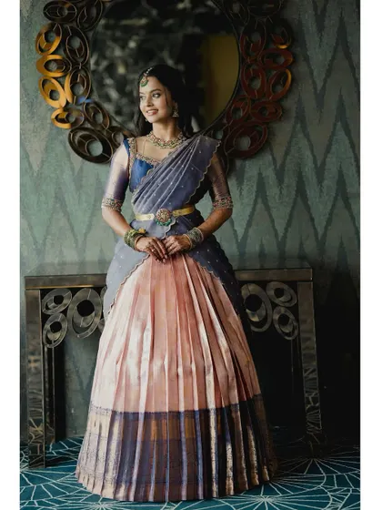 The rich textures of the upcycled Kanjivaram silk shine in this full-length portrait of Brunda.