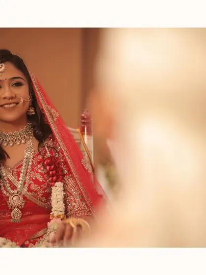 The bride's radiant smile as she looks at her groom. This over-the-shoulder shot captures her perspective, filled with love and anticipation for the life they are about to build.