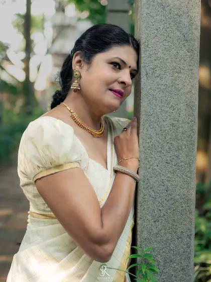 A close-up of the Kerala saree look, focusing on the delicate gold jewelry and the puff-sleeve blouse I designed to complement the simple elegance of the saree.