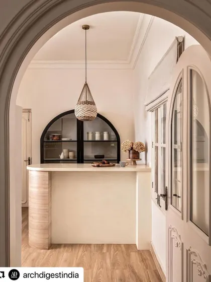 As seen from the arched doorway, the bar area becomes an inviting destination within the home. This view shows how I use architectural framing to create distinct yet connected spaces.